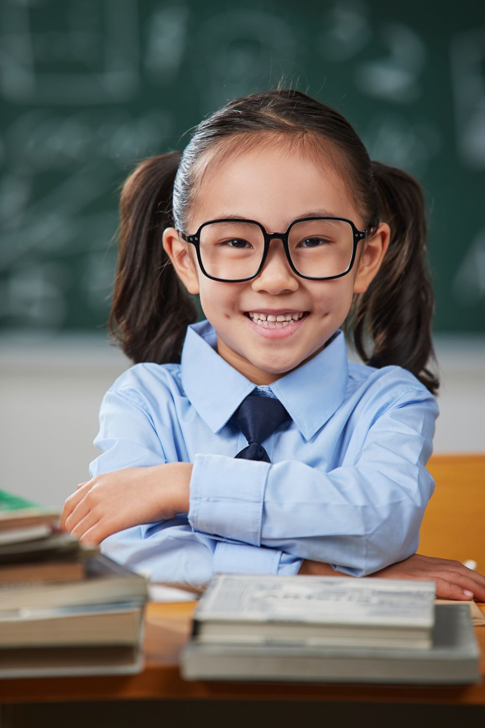 Smiling girl at her school desk