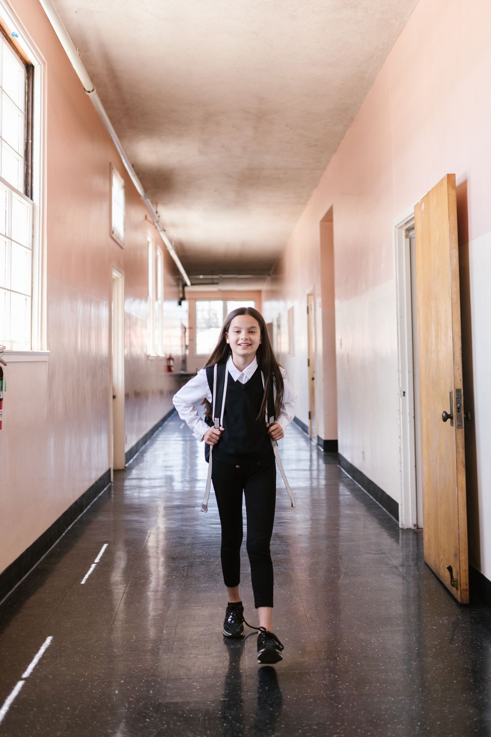 Girl walking down a school hallway in uniform